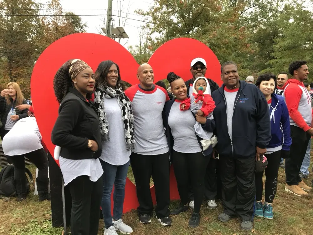Participants posing with the large red heart display