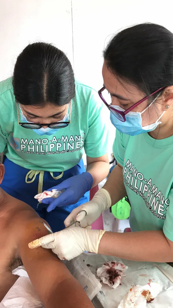 Volunteers providing medical treatment to a patient
